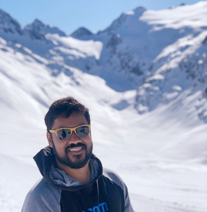 Portrait of Arghya Mukherjee in front of snowy mountains